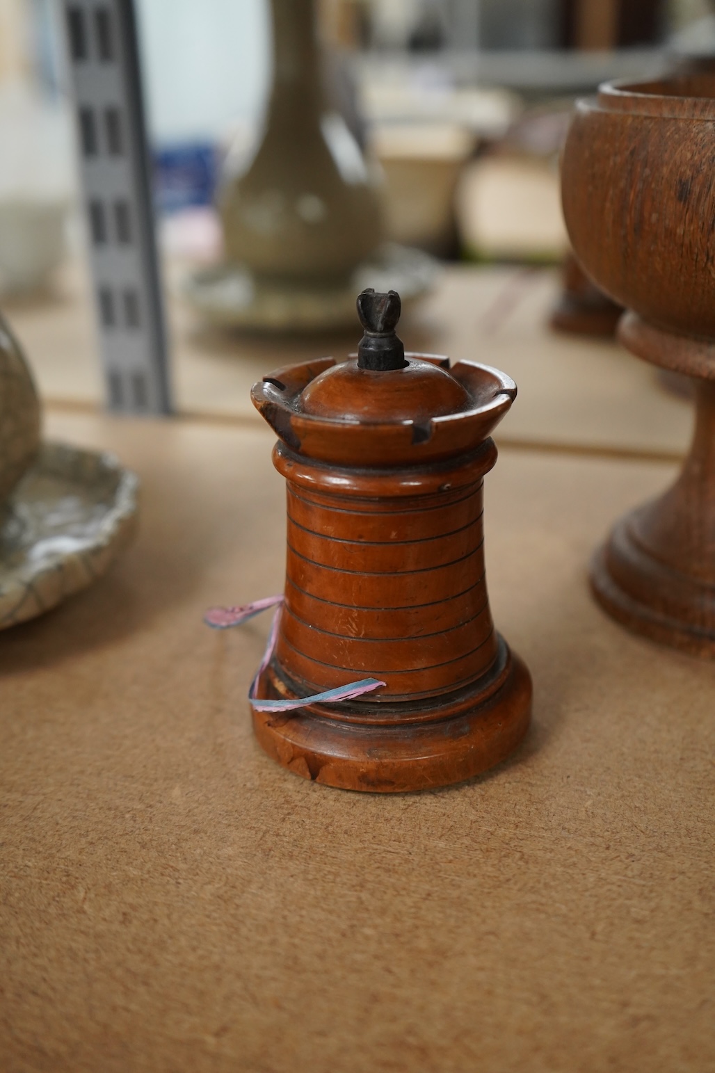 A 19th century treen tower tape measure and an oak goblet with provence label, 13cm